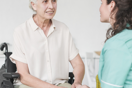 happy disabled nurse sitting wheel chair looking caretaker